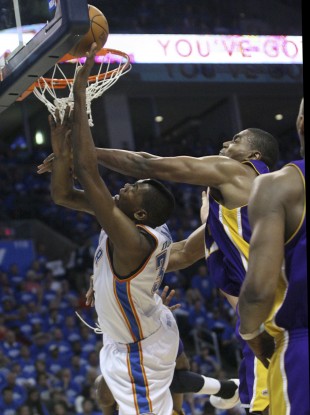 Oklahoma City Thunder forward Kevin Durant, left, is fouled by Los Angeles Lakers center Andrew Bynum, right, in the third quarter of Game 3 of a first-round NBA basketball playoff series
