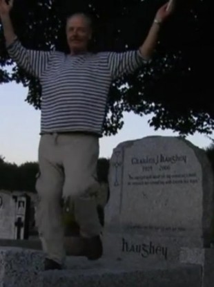 A screen grab of Vincent Keaney's video in which he dances on the grave of Charles Haughey.