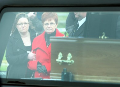 Peter's sister Anne, and her daughter Francis, watch a coffin with Peter Wilson's remains being removed from Waterfoot beach in the Glens of Antrim.