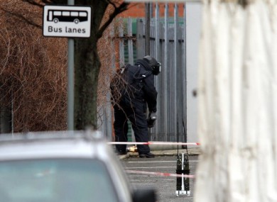 Bomb disposal expert, prepares to examine an object, in an alleyway close to Xtravision, on the Antrim road not far from a police station in north Belfast during a bomb alert.