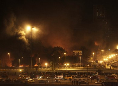 Fires from burning buildings are seen at night on the Corniche, an area of the city taken over by anti-government protesters, in downtown Cairo, Egypt. this evening.