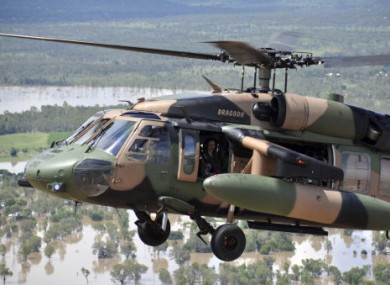 Australian PM Julia Gillard surveys the flood damage from the open window of an army helicopter