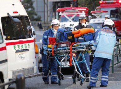 Tokyo Fire Department rescue workers arrive at Kudan Kaikan in Tokyo as local media said its ceiling was damaged after a strong earthquake and injured people inside the hall Friday, March 11, 2011.