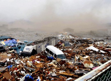 A huge tidal wave washes away houses and cars at Kesennuma port on Friday, in Miyagai Prefecture, March 11, 2011.