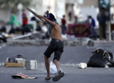 A Shia Bahraini youth holds a piece of wood in the streets of Malkiya, Bahrain, Wednesday, March 16 2011.