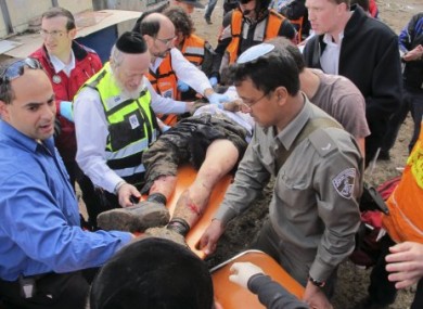 Israeli rescue workers and paramedics treat an injured man after an explosion near a bus stop in Jerusalem, Wednesday, March 23, 2011.