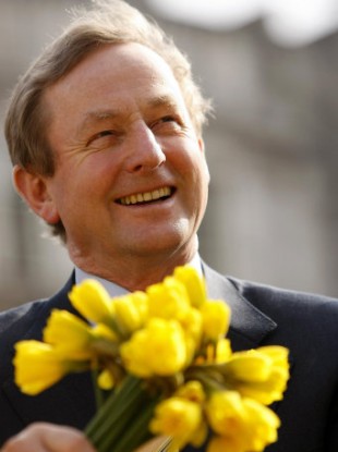 Taoiseach Enda Kenny sits by the fountain in Government Buildings during the launch of Daffodil Day in aid of the Irish Cancer Society.