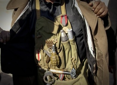 A Libyan rebel displays his ammunition before moving closer to the frontline after Moammar Gadhafi's forces fired on them on the frontline of the outskirts of the city of Ajdabiya, south of Benghazi, eastern Libya, Tuesday, March 22, 2011.