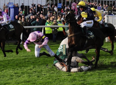 Ruby Walsh takes a tumble from Sire Collonges at the final hurdle in the Silver Cross Hurdle Race at Aintree today.