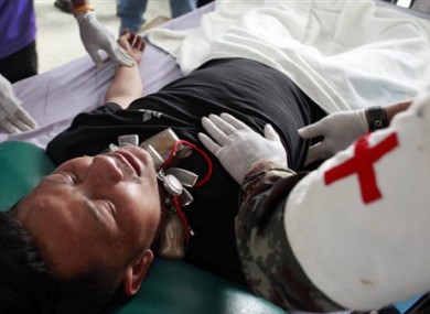 Medical personnel examine an injured Thai soldier at a hospital following clashes between Thai and Cambodia in Surin province, northeastern Thailand, Thursday, April 28, 2011.