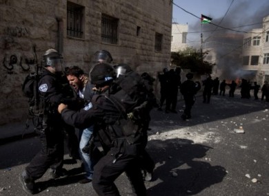 Israeli troops arrest a Palestinian protester, during a demonstration to mark the 63rd anniversary of