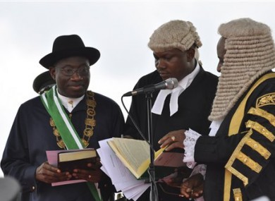Nigerian President Goodluck Jonathan, left, takes the oath of office before Justice Sunday Olorundanusi, center, and Chief Justice of Nigeria Katsina Alu during his inauguration ceremony.
