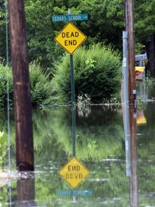 A traffic sign is reflected in the Mississippi flood waters in south Vicksburg, Mississippi.