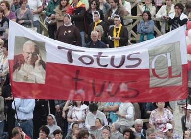 Faithful hold a banner reading in latin Totus tuus (Totally yours) during a thanksgiving Mass in St. Peter's Square at the Vatican, Monday, May 2, 2011.