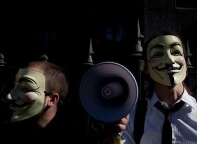 File photo people wearing masks often used by a group that calls itself