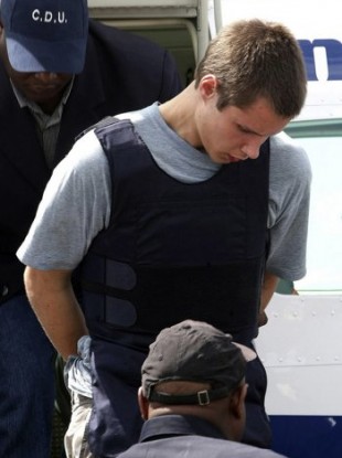 Colton Harris-Moore is escorted by police last July.