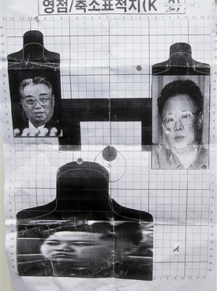 This May 29, 2011 photo shows a firing target depicting North Korea's founder Kim Il Sung, left, leader Kim Jong Il, right, and Kim Jong Il's son Kim Jong Un, bottom, used for reserve forces drills in Seoul, South Korea.