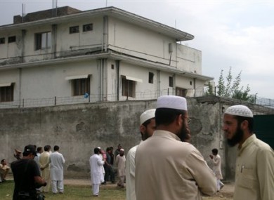 In this May 5, 2011 file photo, local residents and media are seen outside the house where al-Qaeda leader Osama bin Laden was caught and killed in Abbottabad, Pakistan.