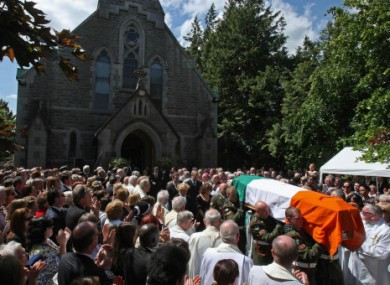 The coffin bearing the remains of Brian Lenihan is carried away from St Mochta's Church in Porterstown, Dublin this morning following his funeral Mass