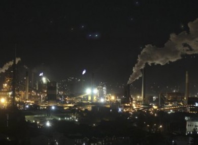 Smoke bellows out of chimney stacks at BlueScope Steel's steelworks at Port Kembla, south of Sydney, Australia.