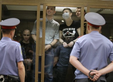 Members of the country's most vicious neo-Nazi gang stands behind a glass wall at a court in Moscow, Russia, July 11, 2011.