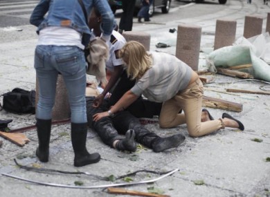 A victim is treated outside government buildings in the centre of Oslo.