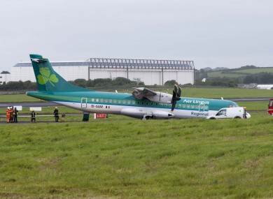 The Aer Arann aircraft, carrying Aer Lingus branding, lies just off the runway after the incident at Shannon Airport this afternoon.