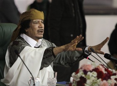 In this Wednesday, March 2, 2011 file photo, Libyan Leader Moammar Gadhafi gestures to supporters as he speaks in Tripoli, Libya.
