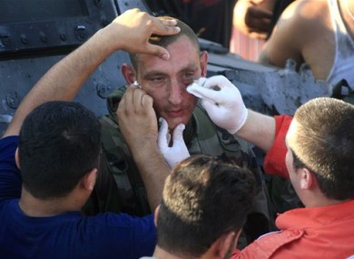 Lebanese red cross workers treat an injured French UN peacekeeper.
