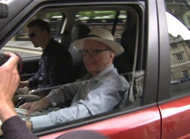 News Corp CEO Rupert Murdoch rolls down the window of the vehicle taking him to his apartment in St James's, central London to enable photographers to take pictures Sunday July 10, 2011.