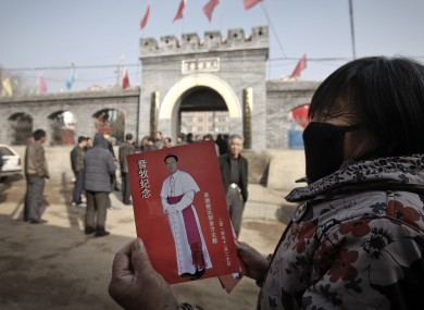 A village woman shows a leaflet with a picture of Bishop Guo Jincai, which was distributed by worshipers after the bishop ordination ceremony in November
