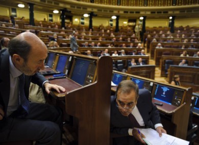 Socialist Party presidential candidate Alfredo Perez Rubalcaba, left, speaks with the socialist party spokesman for the parliament Jose Antonio Alonso during a extraordinary plenary session at the Spanish Parliament in Madrid, Tuesday Aug. 30, 2011.