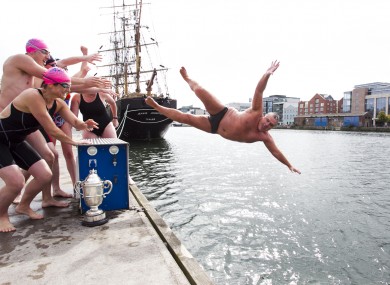 2010 Liffey Swim winner Brian O'Dwyer is pushed into the river during today's announcement of this year's race.
