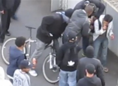 A gang of youths surround Rossli, 20, who had been attacked and mugged in the street by an earlier group during rioting Monday 8 Aug 2011.