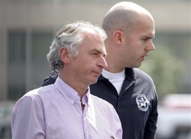 Paul Douglas Peters, left, of Sydney, Australia, is escorted from the Federal Courthouse in Louisville, Kentucky, yesterday.