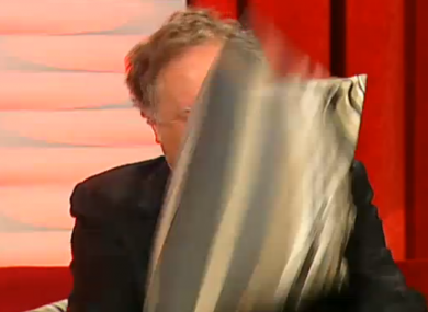Vincent Browne takes cover from a cushion thrown by Jedward on the first edition of Friday Late with Vincent Browne.