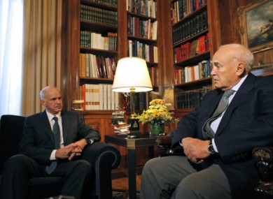 Greece's prime Minister George Papandreou, left speaks to Greek President Karolos Papoulias, today