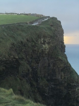 Sandra Clifford's photograph of the Cliffs of Moher featuring the apparently human image to he centre-right of the cliff front.