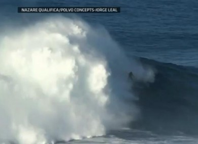 Surfer Garrett McNamara riding the mammoth wave in Portugal yesterday