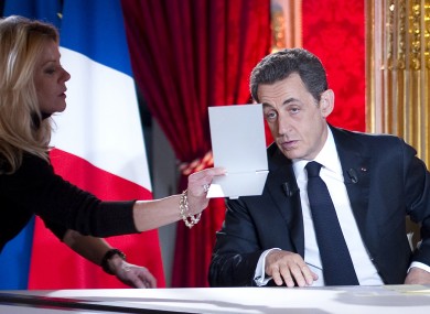 Nicolas Sarkozy looks in a mirror as he prepares for his interview on French TV last night.