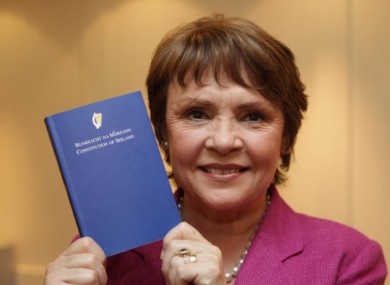 Presidential candidate from 2011, Dana Rosemary Scallon, holding a copy of Ireland's constitution.