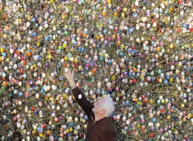 Retired German couple Volker and Christa Kraft decorate a tree in their garden with 10,000 Easter eggs today. They've continued the tradition for more than forty years.