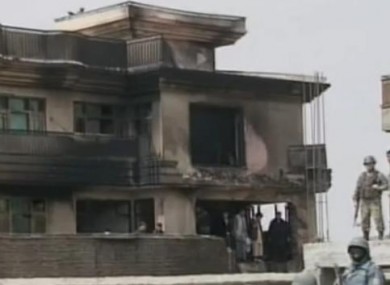 Security forces and local residents at the scene of today's crash.