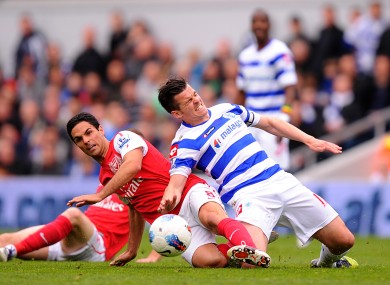 Mikel Arteta slides in to win the ball from QPR's Joey Barton