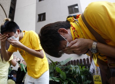 Protesters try to recover from tear gas fired by Malaysian police