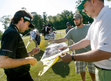 Masters champ Bubba Watson signs autographs for fans yesterday.