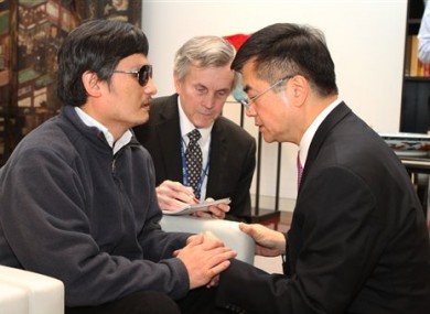 In this photo released by the US Embassy Beijing Press Office, blind lawyer Chen Guangcheng, left, talks with U.S. ambassador to China, Gary Locke