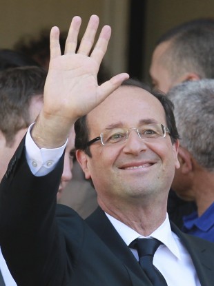 Francois Hollande waves after voting today