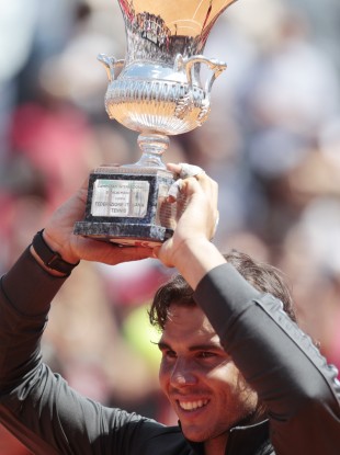 Rafael Nadal hoists the Italian Open trophy.