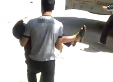 Image made from amateur video released by Shaam News Network purports to show a wounded child being evacuated in Aleppo, Syria